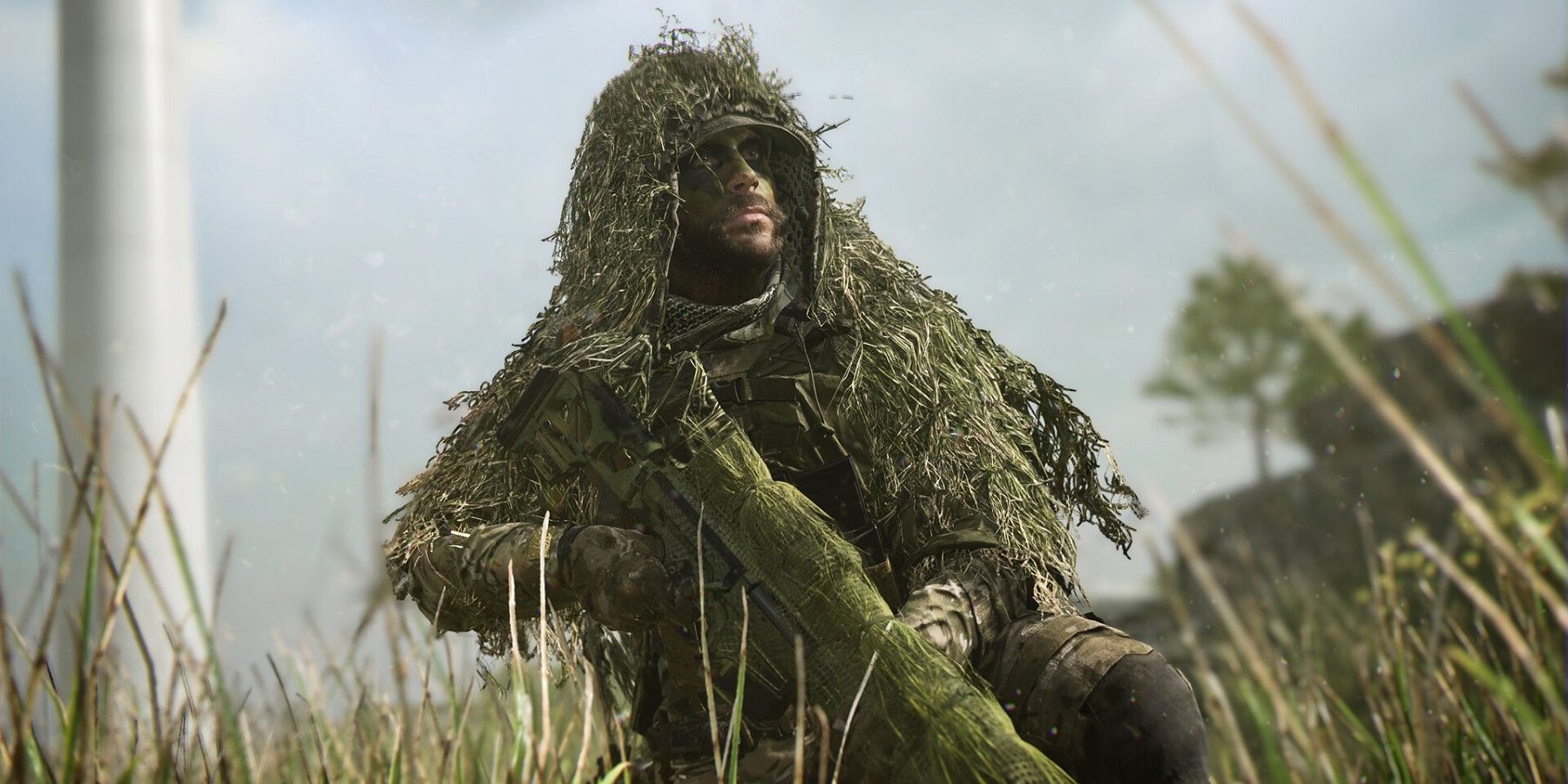 A scene from call of duty depicting a soldier in ghillie suit holding a rifle in the bush